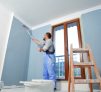 istockphoto-1198703852-612x612 Painter man at work takes the color with paint roller from the bucket. With copy space